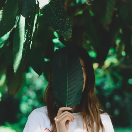 Woman Holding Leaf Face